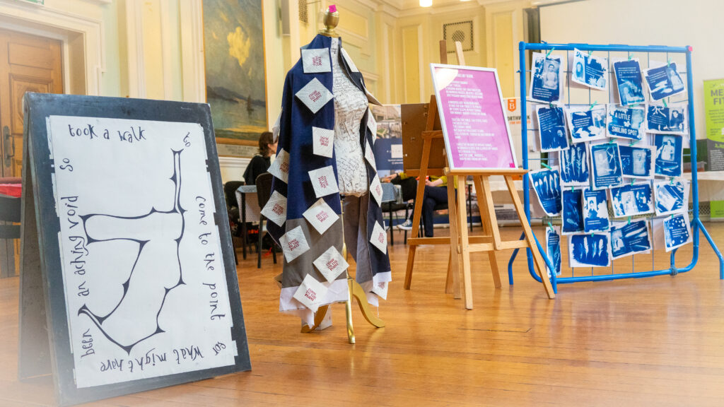 Photo from the 'Stories of Mental Health' Exhibition. Shows several art works including the 'Come to the point' mannequin.